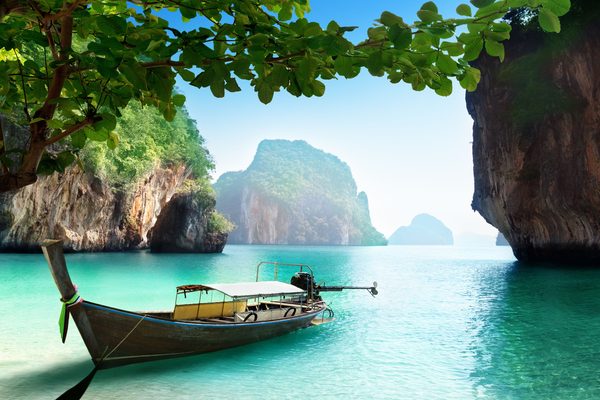 Un longtail ormeggiato fra le falesie di un isolotto di Krabi